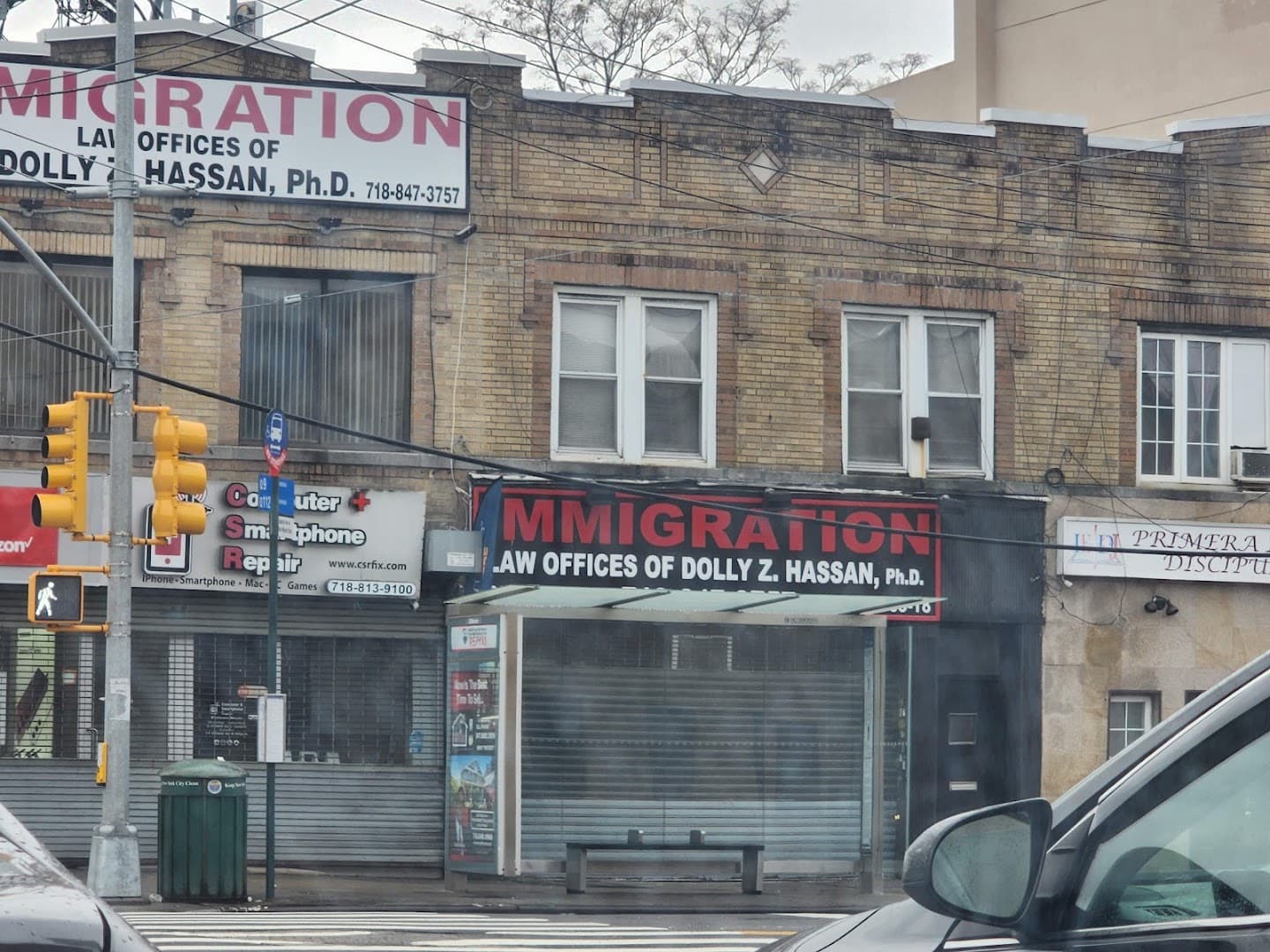 The Liberty Avenue storefront under the Law Offices of Dolly Z. Hassan sign