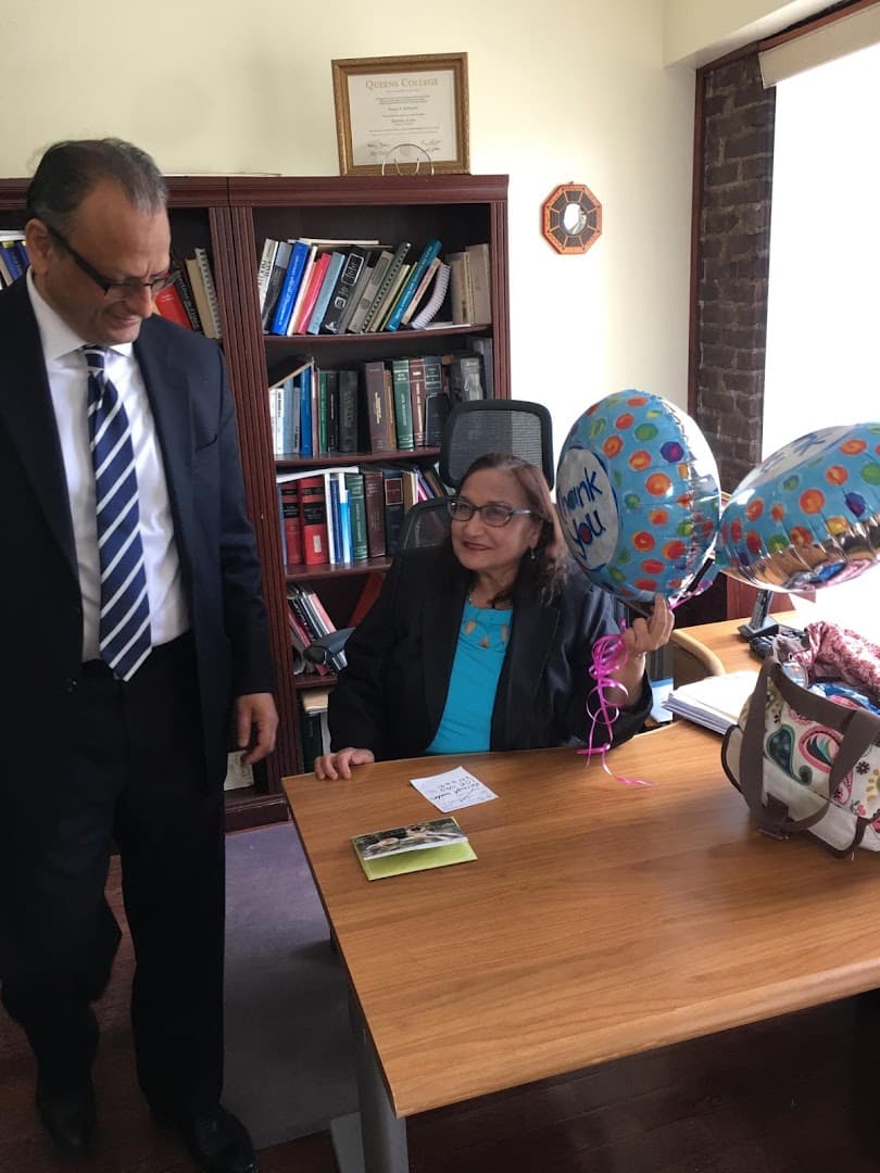 Dolly Z. Hassan, Ph.D. at her desk in the South Richmond Hill office, with Mr. Rahaman